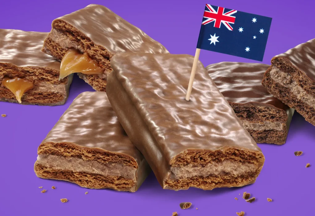 A close-up of classic Tim Tams, featuring a crunchy biscuit with creamy chocolate filling and a smooth chocolate coating, showcasing the iconic Australian treat.