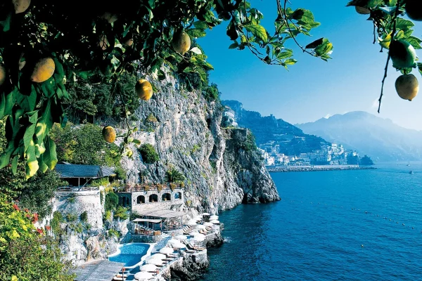 Amalfi Coast: Supercharge Your Adventure with History & Beauty Colorful houses of Positano cascading down a cliffside on the Amalfi Coast