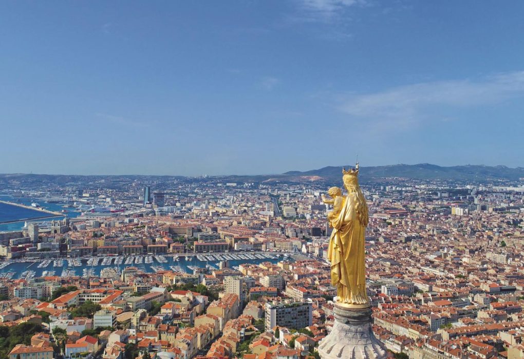 Aerial view of Marseille's Vieux-Port with boats docked and historic buildings lining the waterfront