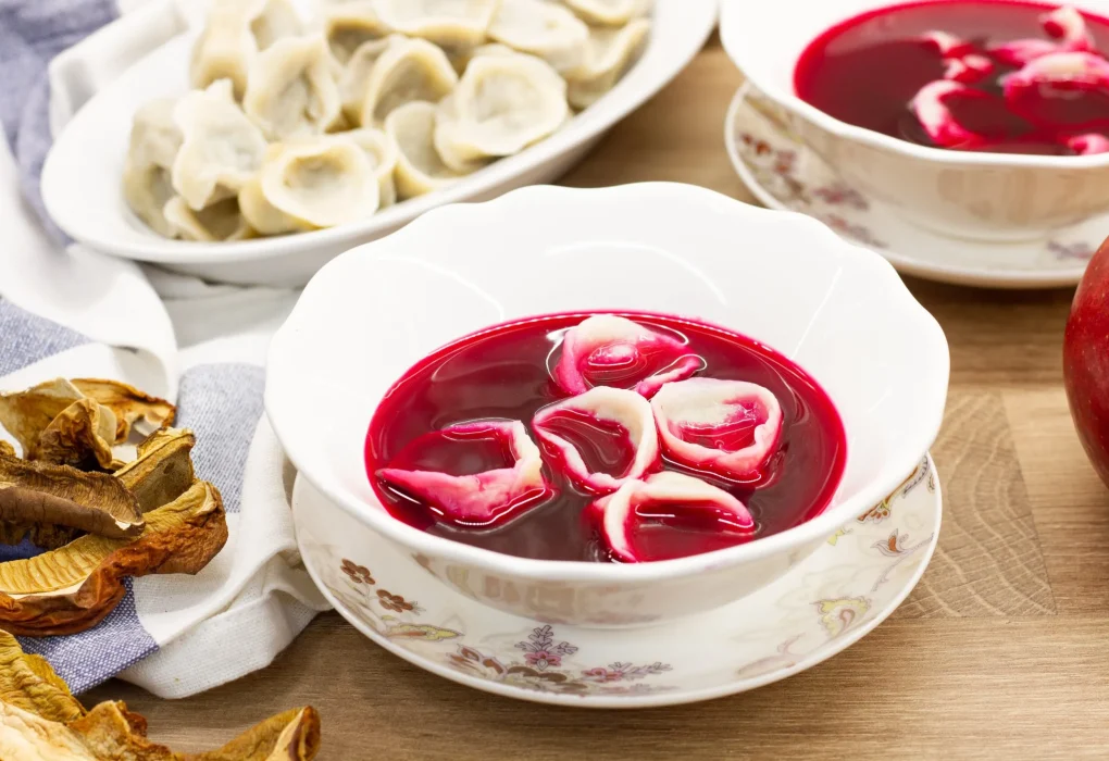 Bowl of vibrant borscht garnished with sour cream and dill