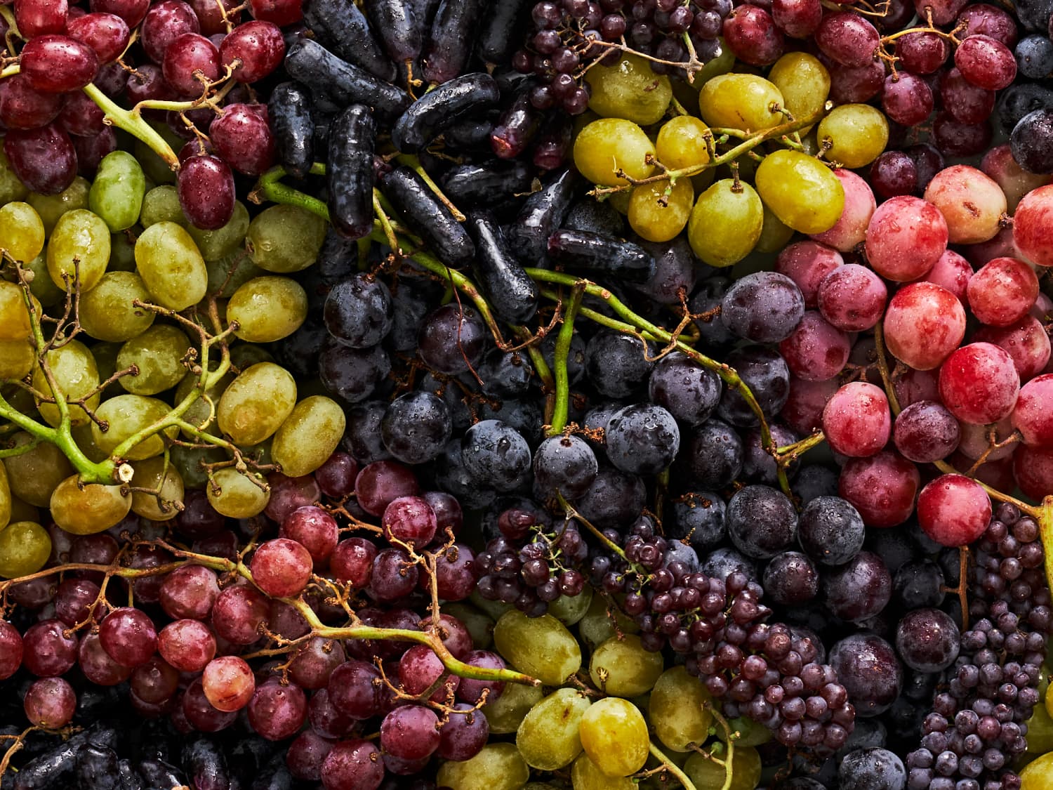 A bowl of fresh grapes on a kitchen counter.