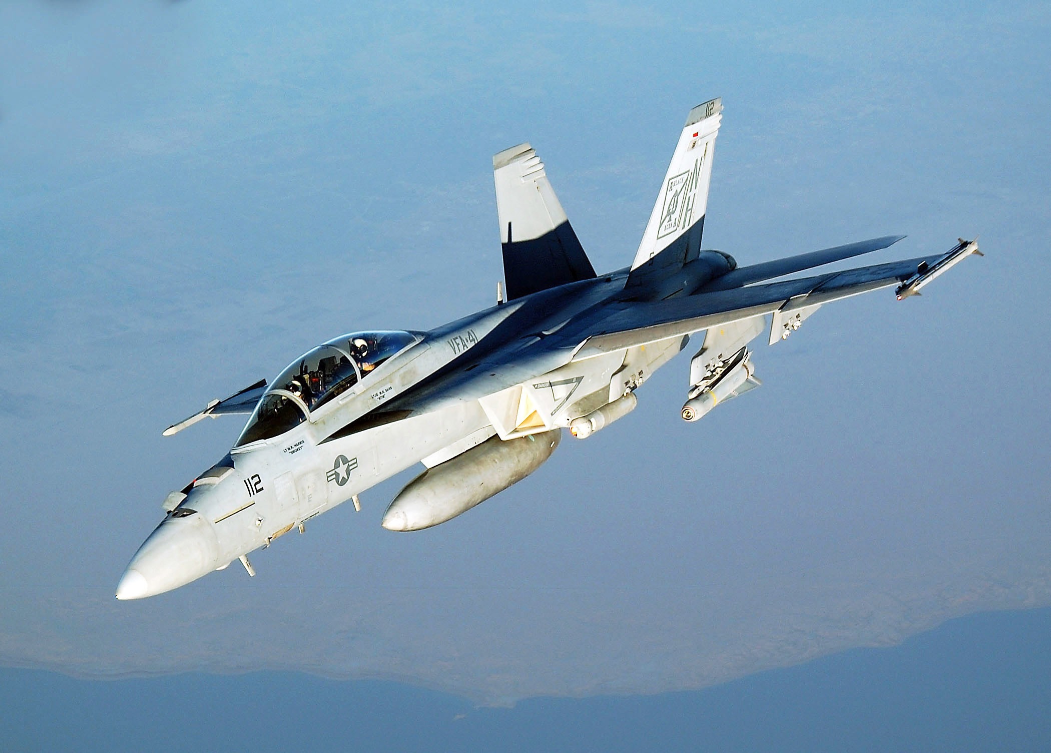 F/A-18 Hornet in flight over the ocean, showcasing its versatility.