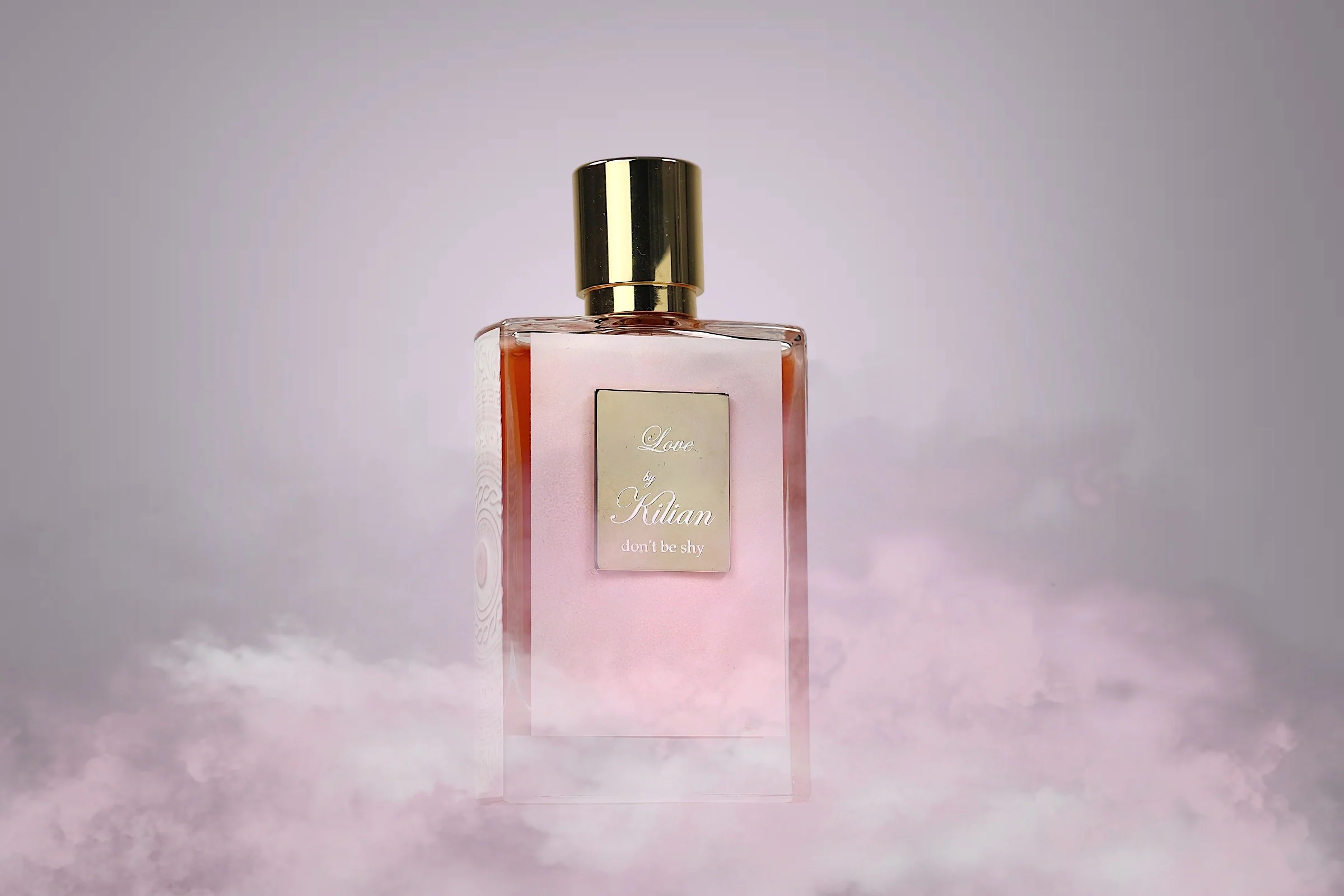 A woman holding Kilian Love, showcasing its timeless elegance